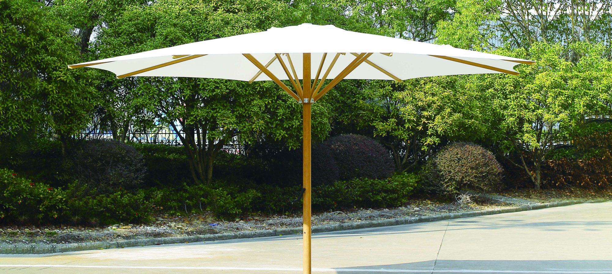 Wood-finish central-pole parasol in a private garden