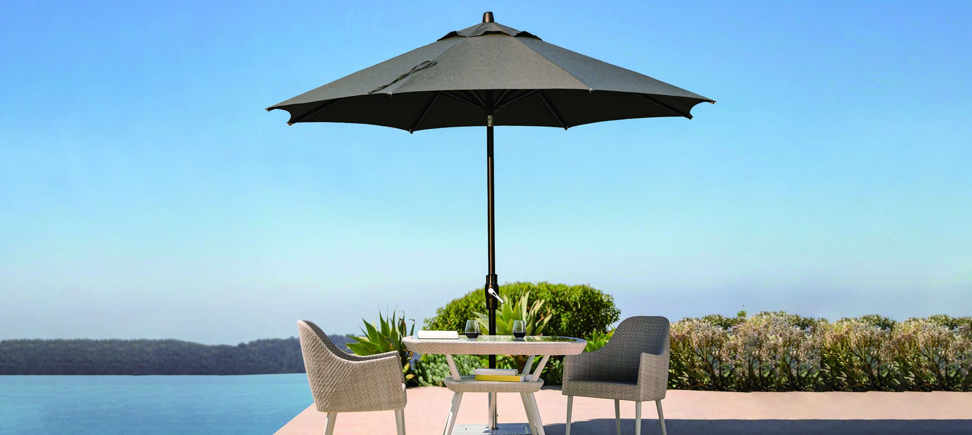 Classic central-pole parasol on a sea-view terrace